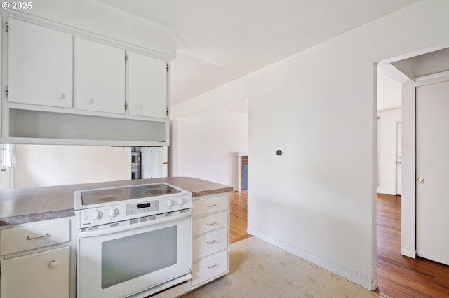 10438 NE Davis St, Portland, OR 97220 - kitchen featuring white electric range oven, light floors, white cabinets, baseboards, and light countertops