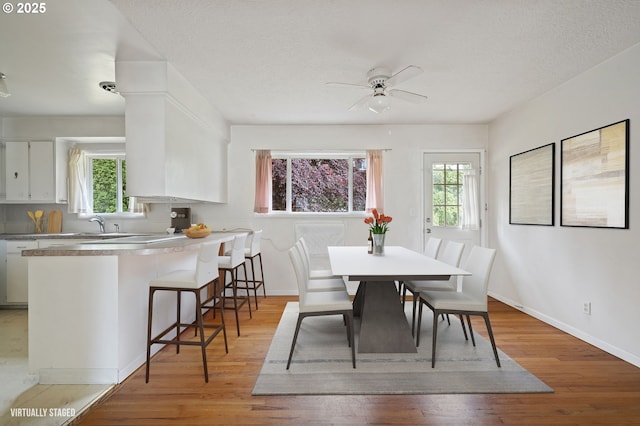 10438 NE Davis St, Portland, OR 97220 - dining room with plenty of natural light, ceiling fan, light wood-type flooring, and a textured ceiling
