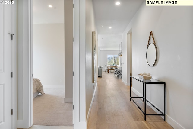 corridor with light hardwood / wood-style flooring