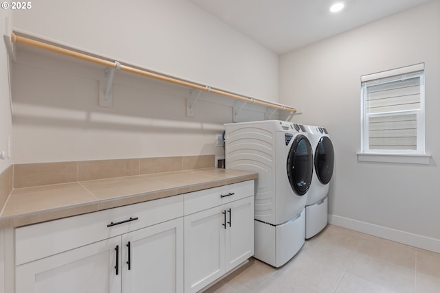 16679 SW Darwin Loop, Portland, OR 97224 - laundry room with washing machine and dryer, light tile patterned floors, baseboards, recessed lighting, and cabinet space