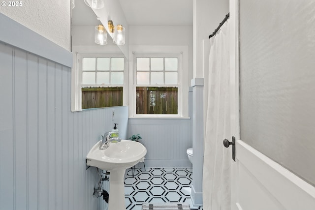 bathroom with toilet and tile patterned floors