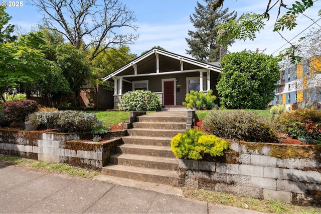 view of front of property with covered porch and fence