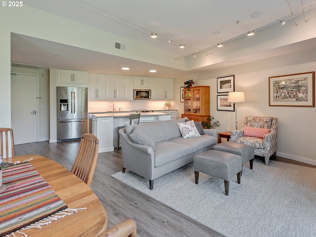 12600 SW Crescent St Unit 213, Beaverton, OR 97005 - living room with wood finished floors, baseboards, and recessed lighting