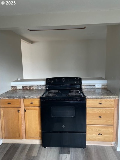 kitchen featuring black electric range and wood finished floors