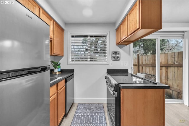 kitchen featuring light wood-type flooring and appliances with stainless steel finishes