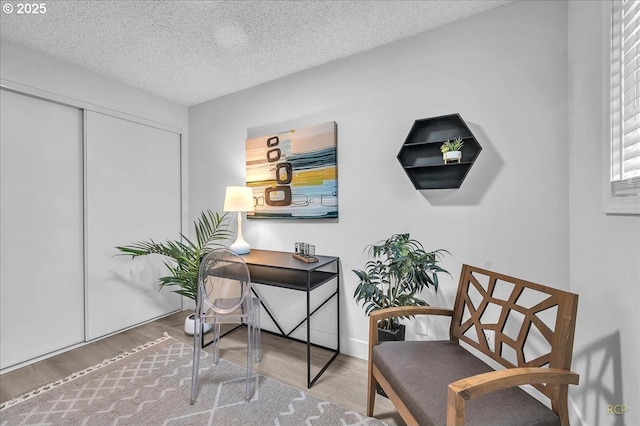 interior space with hardwood / wood-style floors and a textured ceiling