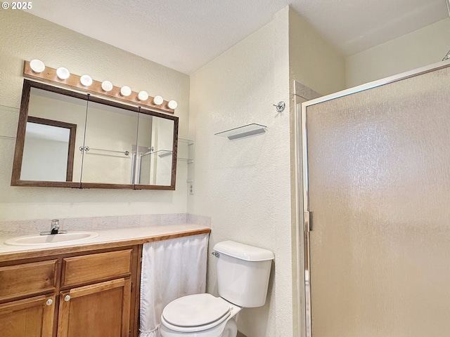 550 Velopa Ct, Brookings, OR 97415 - full bathroom with a textured wall, a shower stall, vanity, and toilet