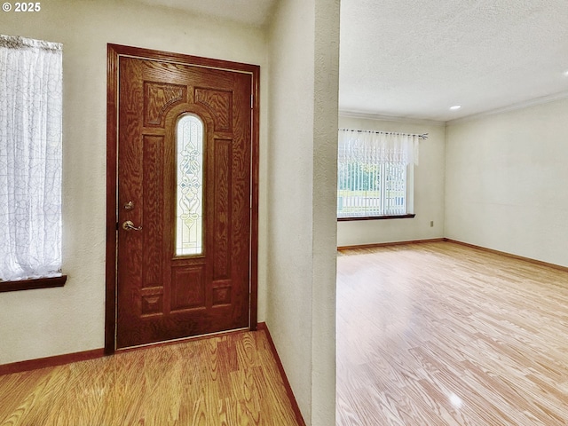 550 Velopa Ct, Brookings, OR 97415 - entrance foyer featuring wood finished floors, baseboards, crown molding, and a textured ceiling