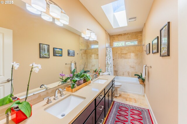 35908 Chinook St, Sandy, OR 97055 - bathroom with double vanity, a skylight, shower / bath combo, toilet, and baseboards