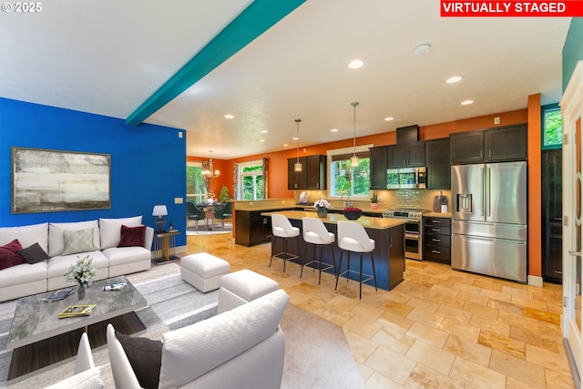 35908 Chinook St, Sandy, OR 97055 - living room with recessed lighting, a chandelier, and stone tile floors