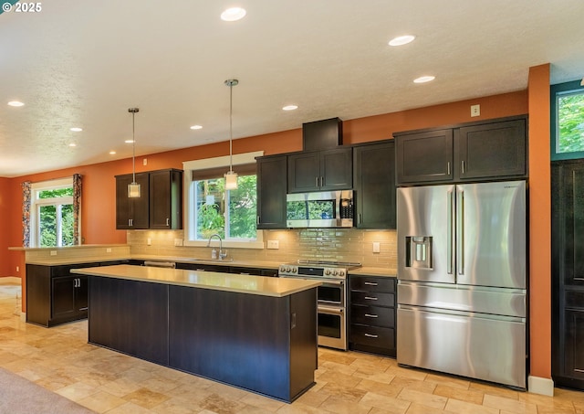 35908 Chinook St, Sandy, OR 97055 - kitchen featuring stainless steel appliances, a sink, recessed lighting, light countertops, and a kitchen island