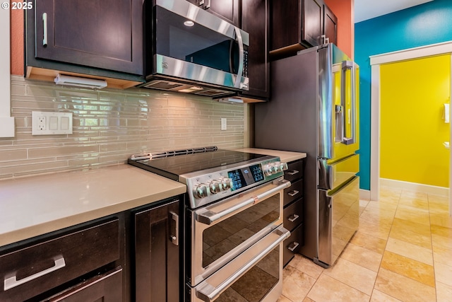 35908 Chinook St, Sandy, OR 97055 - kitchen featuring appliances with stainless steel finishes, dark brown cabinetry, decorative backsplash, light countertops, and baseboards