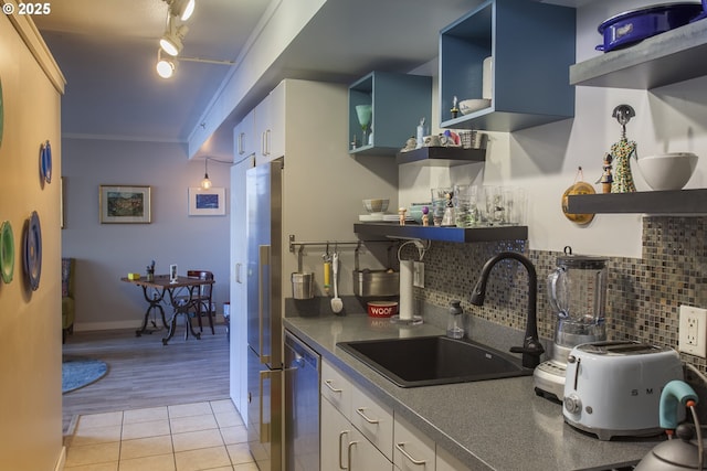 533 NE Holladay St Unit 308, Portland, OR 97232 - kitchen with open shelves, appliances with stainless steel finishes, dark countertops, decorative backsplash, and blue cabinetry