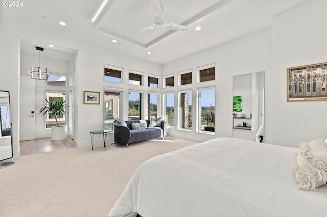 carpeted bedroom featuring recessed lighting, baseboards, and a high ceiling