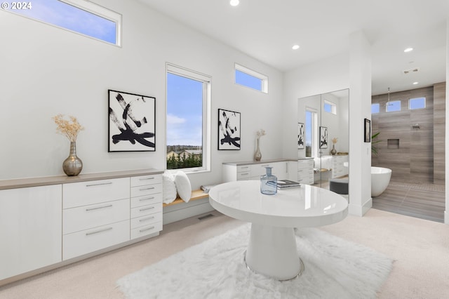 full bathroom featuring recessed lighting, a freestanding tub, and visible vents