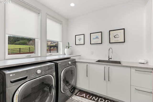 clothes washing area featuring cabinet space, recessed lighting, independent washer and dryer, and a sink