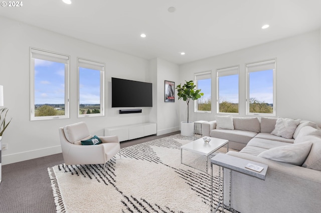 living area with recessed lighting and baseboards