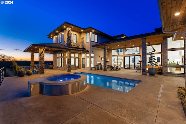 view of swimming pool with a patio and a pool with connected hot tub