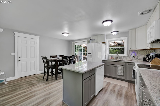 1533 Sequoia Ave, Springfield, OR 97477 - kitchen with white appliances, gray cabinetry, a sink, decorative backsplash, and light wood-type flooring