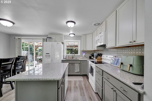 1533 Sequoia Ave, Springfield, OR 97477 - kitchen with white appliances, gray cabinets, light wood-style flooring, and tasteful backsplash