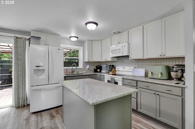 1533 Sequoia Ave, Springfield, OR 97477 - kitchen featuring white appliances, a sink, a kitchen island, gray cabinetry, and light wood finished floors