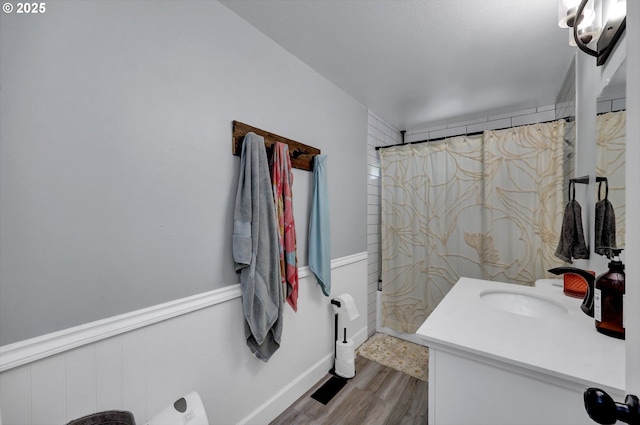 1533 Sequoia Ave, Springfield, OR 97477 - full bathroom featuring vanity, wood finished floors, a shower with shower curtain, and wainscoting