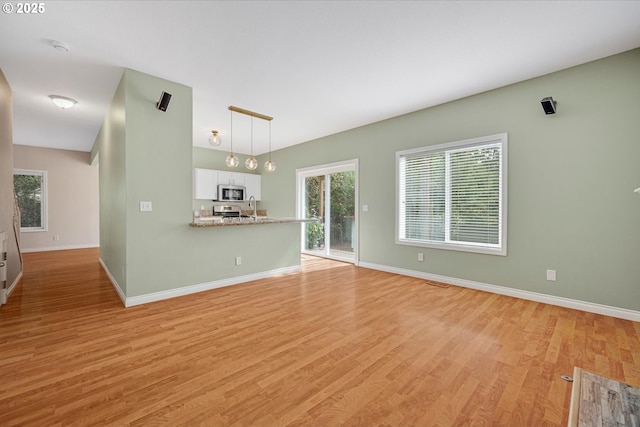 5966 Frost Ln, Lake Oswego, OR 97035 - unfurnished living room featuring light wood-style flooring and baseboards