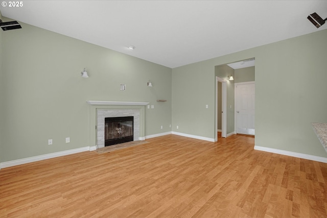 5966 Frost Ln, Lake Oswego, OR 97035 - unfurnished living room featuring light wood-style flooring, a fireplace with flush hearth, and lofted ceiling