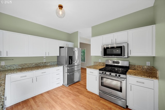 5966 Frost Ln, Lake Oswego, OR 97035 - kitchen featuring stainless steel appliances, light wood-type flooring, white cabinetry, and light stone countertops