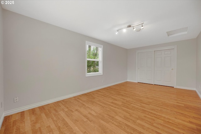5966 Frost Ln, Lake Oswego, OR 97035 - unfurnished bedroom with light wood-style floors, a closet, and attic access