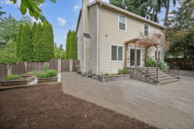 5966 Frost Ln, Lake Oswego, OR 97035 - back of property with a patio, a fenced backyard, a garden, and a pergola