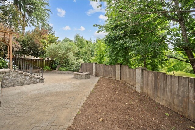 5966 Frost Ln, Lake Oswego, OR 97035 - fenced backyard with a fire pit and a patio area