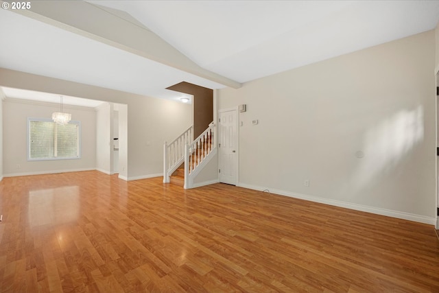 5966 Frost Ln, Lake Oswego, OR 97035 - spare room featuring stairs, light wood-style flooring, a chandelier, and lofted ceiling
