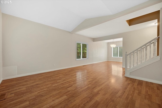 5966 Frost Ln, Lake Oswego, OR 97035 - spare room featuring a chandelier, wood finished floors, vaulted ceiling, and stairway