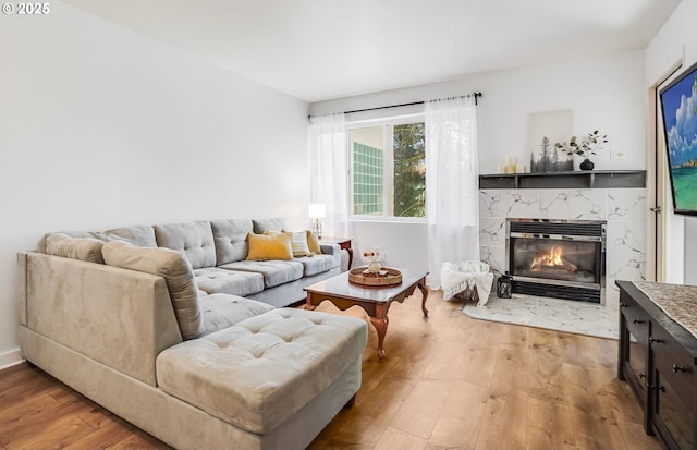 6645 W Burnside St Unit 515, Portland, OR 97210 - living area with light wood-type flooring and a fireplace