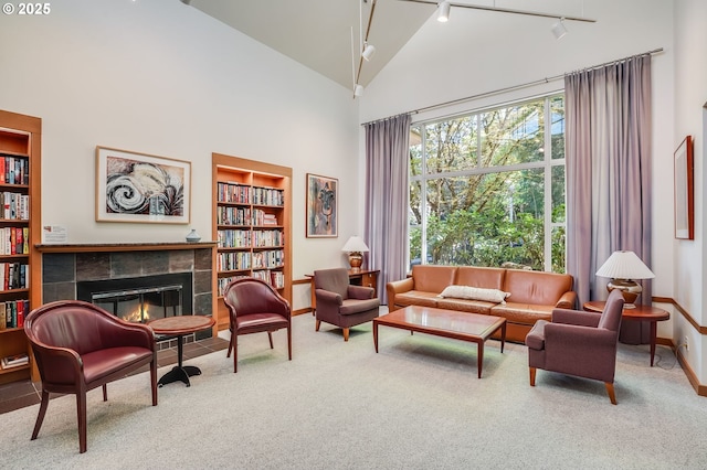 6645 W Burnside St Unit 515, Portland, OR 97210 - living area featuring carpet, track lighting, a tile fireplace, baseboards, and built in features