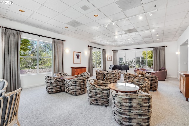 carpeted living area featuring rail lighting, baseboards, and recessed lighting