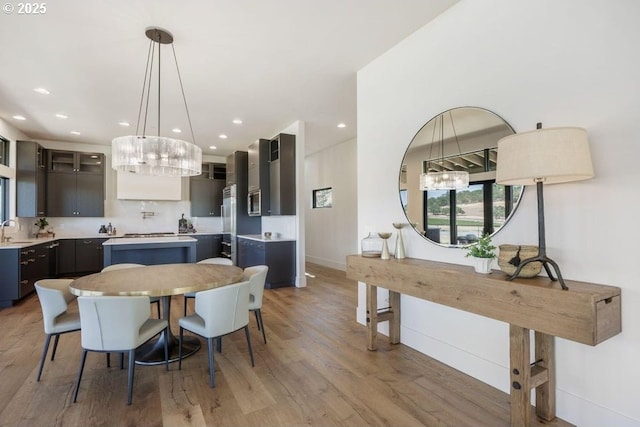 dining space with sink and light wood-type flooring