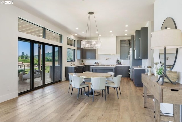 dining room with light hardwood / wood-style floors and sink