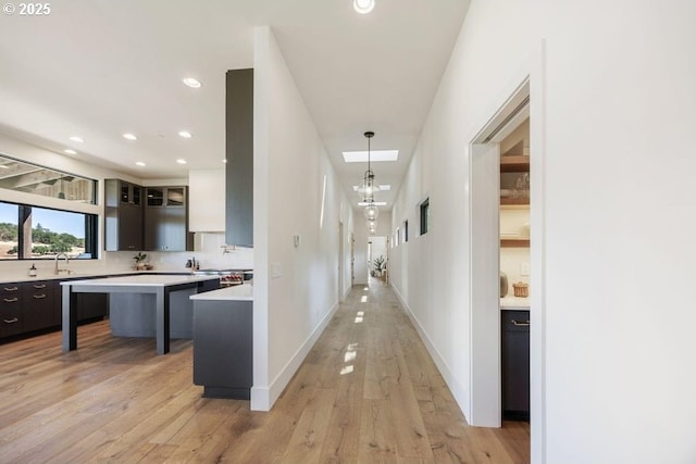 hall with sink and light hardwood / wood-style floors