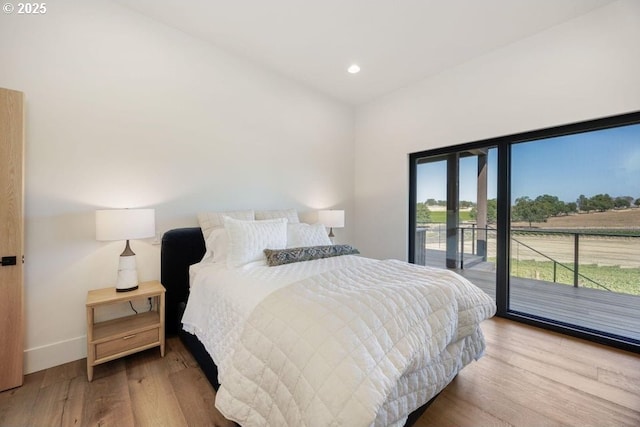 bedroom featuring access to exterior and light hardwood / wood-style flooring