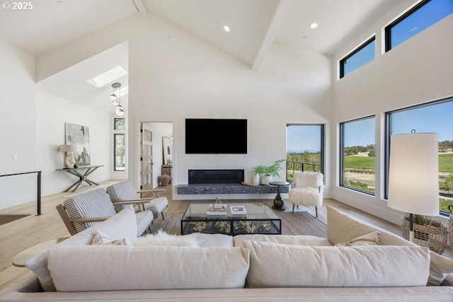 living room featuring light wood-type flooring and a high ceiling