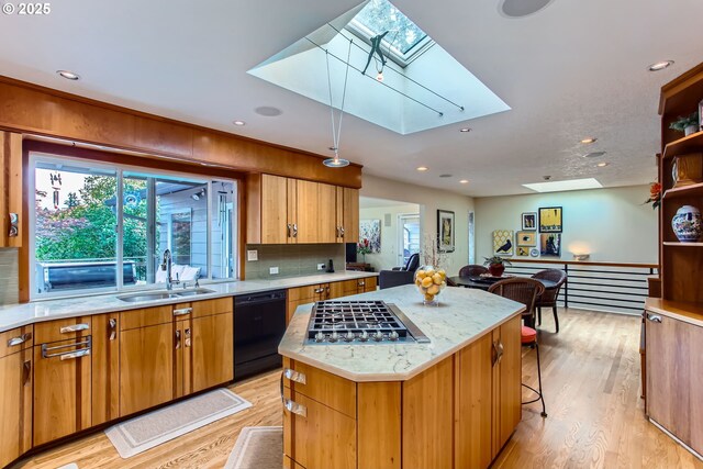 7145 SW Gable Pkwy, Portland, OR 97225 - kitchen featuring a skylight, black dishwasher, a center island, light wood-style floors, and recessed lighting