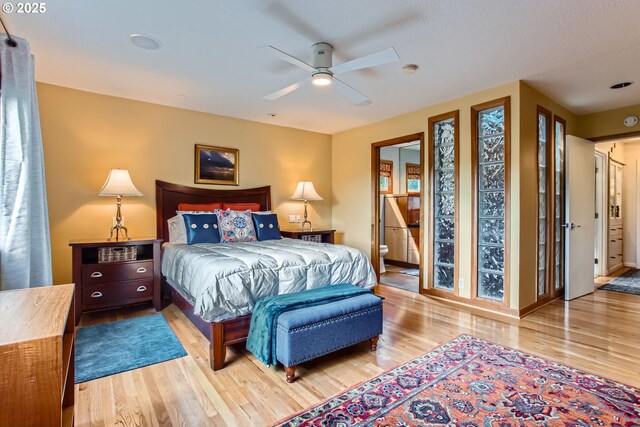 7145 SW Gable Pkwy, Portland, OR 97225 - bedroom with wood finished floors, ensuite bath, and a ceiling fan