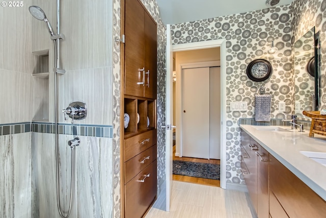 7145 SW Gable Pkwy, Portland, OR 97225 - bathroom featuring wallpapered walls, double vanity, and a shower