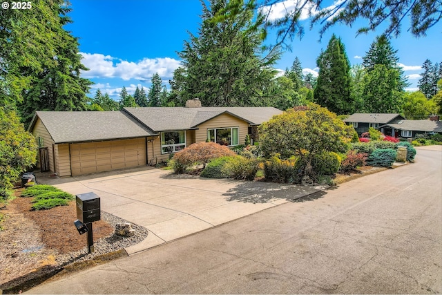 7145 SW Gable Pkwy, Portland, OR 97225 - ranch-style home with an attached garage, driveway, and a chimney