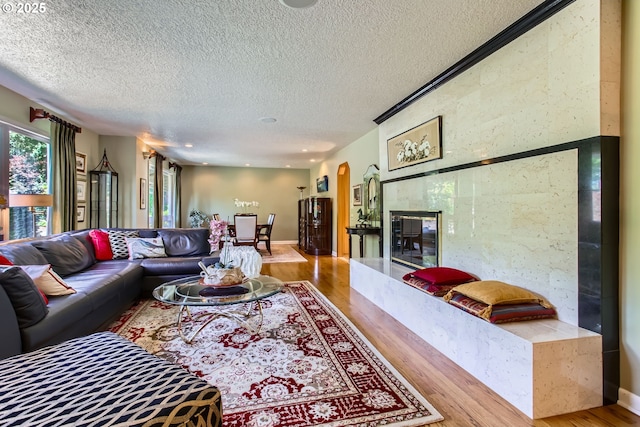 7145 SW Gable Pkwy, Portland, OR 97225 - living area featuring wood finished floors, a textured ceiling, and arched walkways