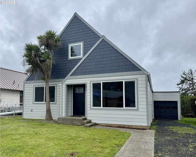 view of front of home featuring a garage and a front lawn