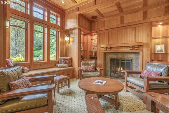 13150 SW Iron Mountain Blvd, Portland, OR 97219 - living area featuring wood walls, wood ceiling with exposed beams, a high ceiling, and a tiled fireplace