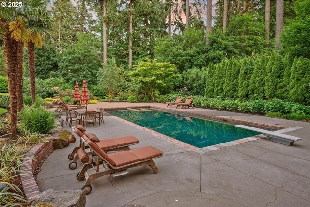 13150 SW Iron Mountain Blvd, Portland, OR 97219 - outdoor pool with a patio, a diving board, and outdoor dining area